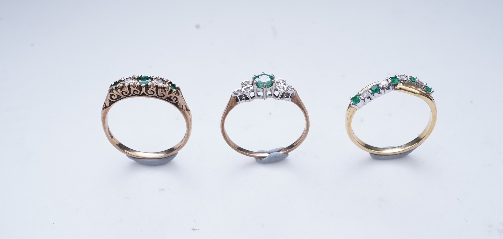 Three emerald and diamond rings